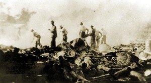 Men standing in the rubble of the Novemeber 28, 1917 Arcade fire. 