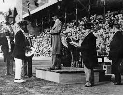 Duke Kahanamoku (holding hat at left) at the 1912 Olympic Games in Stockholm, Sweden.